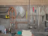 a picture of a workbench with tools hanging on the wall