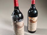 two bottles of wine sitting next to each other on top of a table
