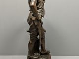 bronze statue of a boy with a dog on a marble base