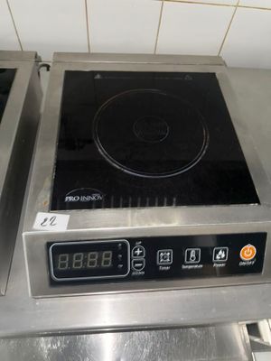 a stove top with a digital display on it in a kitchen