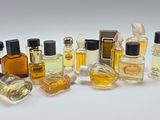 many different types of perfume bottles on a white surface