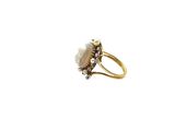 a close up of a gold ring with a pearl and a diamond