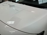 a close up of a white car with a clock on it ' s hood