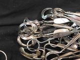 a pile of scissors and other metal objects on a black cloth
