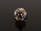 a close up of a ring on a black surface with a reflection