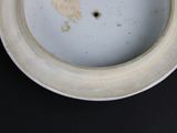 a white plate with a yellow bird on it