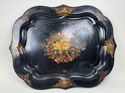 a black tray with a floral design on it