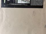 a poster on the wall of a building with a picture of a man in a costume