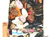 many pairs of shoes and hats in a suitcase