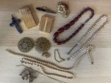 many different types of jewelry on a wooden table