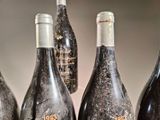 several bottles of wine are lined up on a table