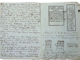 an old book with a page of writing on it and a stamp on the page