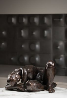 une statue représentant un chien couché sur une table en marbre