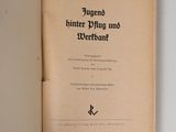 an open book on a white surface with a black writing on it