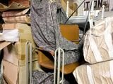a pile of boxes and a chair in a room