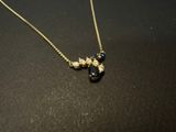 gold plated necklace with black and white beads and a gold chain