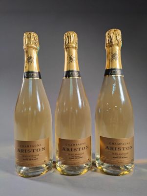 three bottles of wine sitting on top of a table next to each other