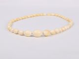 a close up of a beaded bracelet on a white background