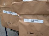 two bags of food sitting on a carton on the floor