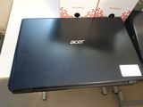 two laptop computers sitting on top of a table next to each other