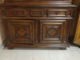 a wooden cabinet with a mirror on top of it
