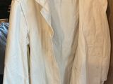 shirt hanging on a hanger in front of a mirror in a room