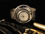 an image of a watch and a pen on a table
