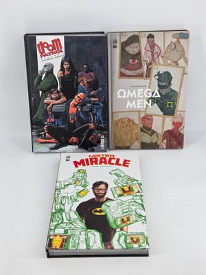 three comic books on a white surface with a white background
