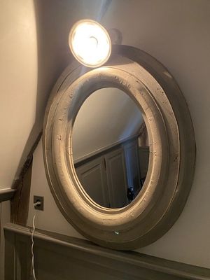 a mirror on the wall above a fireplace in a room