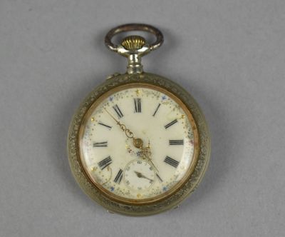 a silver pocket watch with roman numerals on it