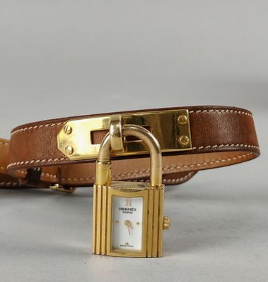 a brown leather belt with a gold padlock on it