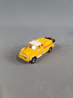 a yellow toy truck that is sitting on a table
