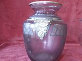 a purple glass vase with a gold leaf decoration on it
