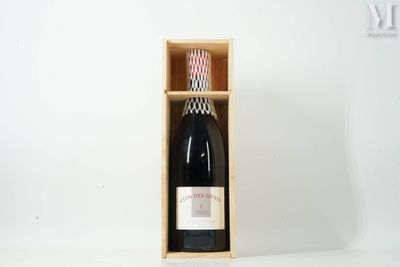 a bottle of wine in a wooden box on a table