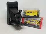 a yellow toy car and a yellow toy car in a box