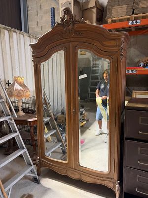 a man standing in front of a large mirror in a room