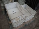 two plastic containers sitting on a pallet in a warehouse