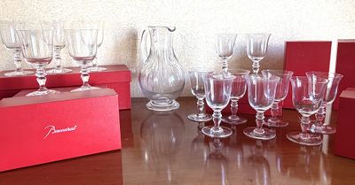 many wine glasses sitting on a table with a red box