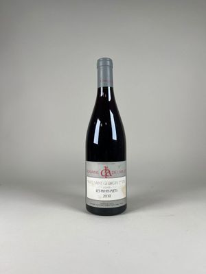 une bouteille de vin rouge posée sur une table blanche