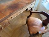 a desk with a chair and a mirror in the room
