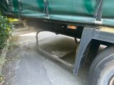 a green truck that is parked on the side of the road