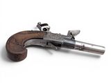a close up of a gun that is on a white surface