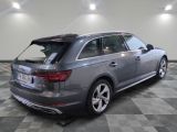 the rear end of a gray audi wagon parked in a garage