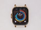 an apple watch with a gold case sitting on top of a white surface