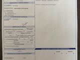 a close up of a receipt on a table with a pen