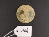 an image of a gold coin with a price tag attached to it