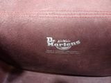 the back of a brown bag with a logo on it