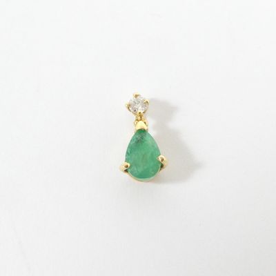 a close up of a pair of earrings with a green tear shaped stone