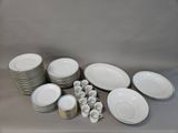 a lot of plates and cups sitting on a table