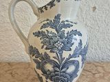 a blue and white vase sitting on a table